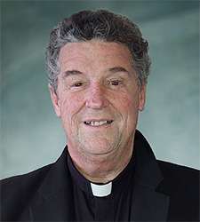 Vandenakker, Fr. John