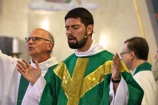 Fr. Isaac Longworth, CC and Fr. Roger Vandenakker, CC praising God.
