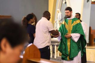 Fr. Isaac Longworth, CC receiving the gifts.